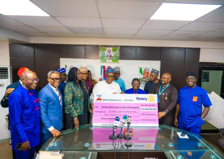 Rotary International handing over symbolic cheque to the Minister of Health Professor Pate and officials of Ministry of health and WHO